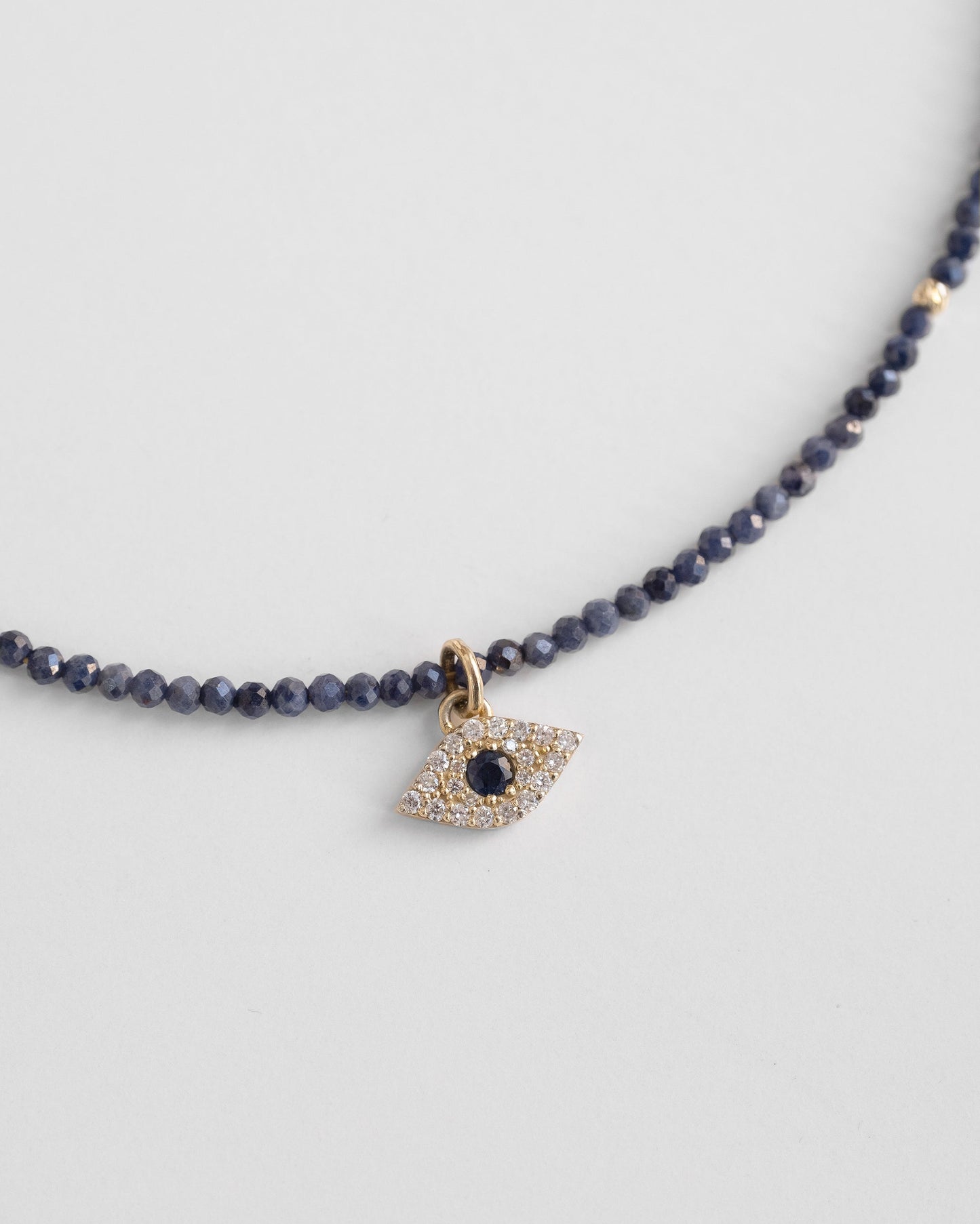 blue beaded necklace with evel eye pendant with sapphire and diamonds