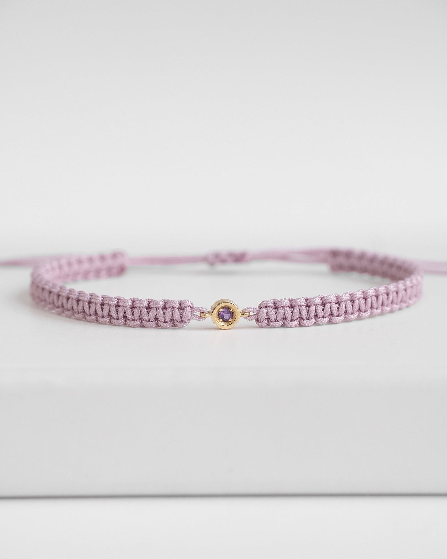 Purple cord bracelet with gold clasp and amethyst 