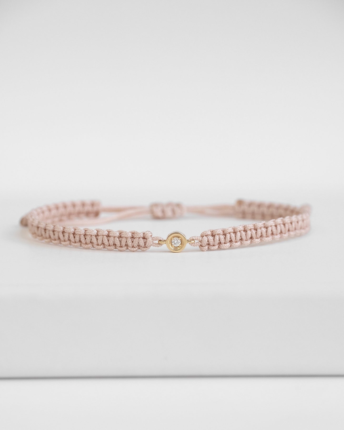 baby pink cord bracelet with diamond and gold clasp