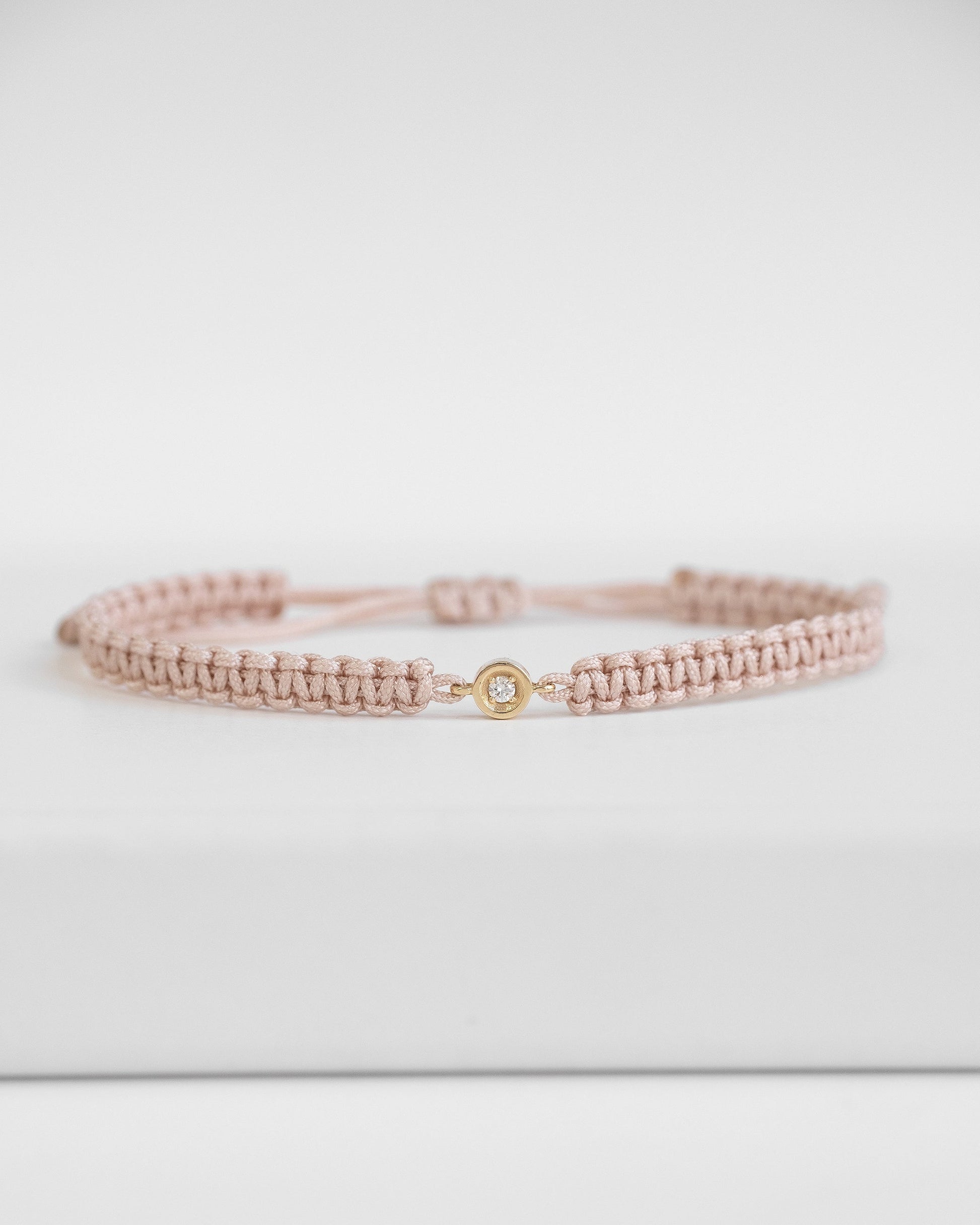 baby pink cord bracelet with diamond and gold clasp