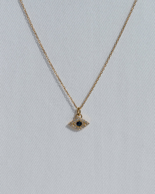 delicate gold chain necklace with evel eye pendant with blue sapphire and diamonds