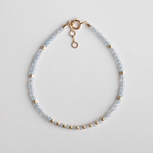 gold bracelet with aquamarine stones