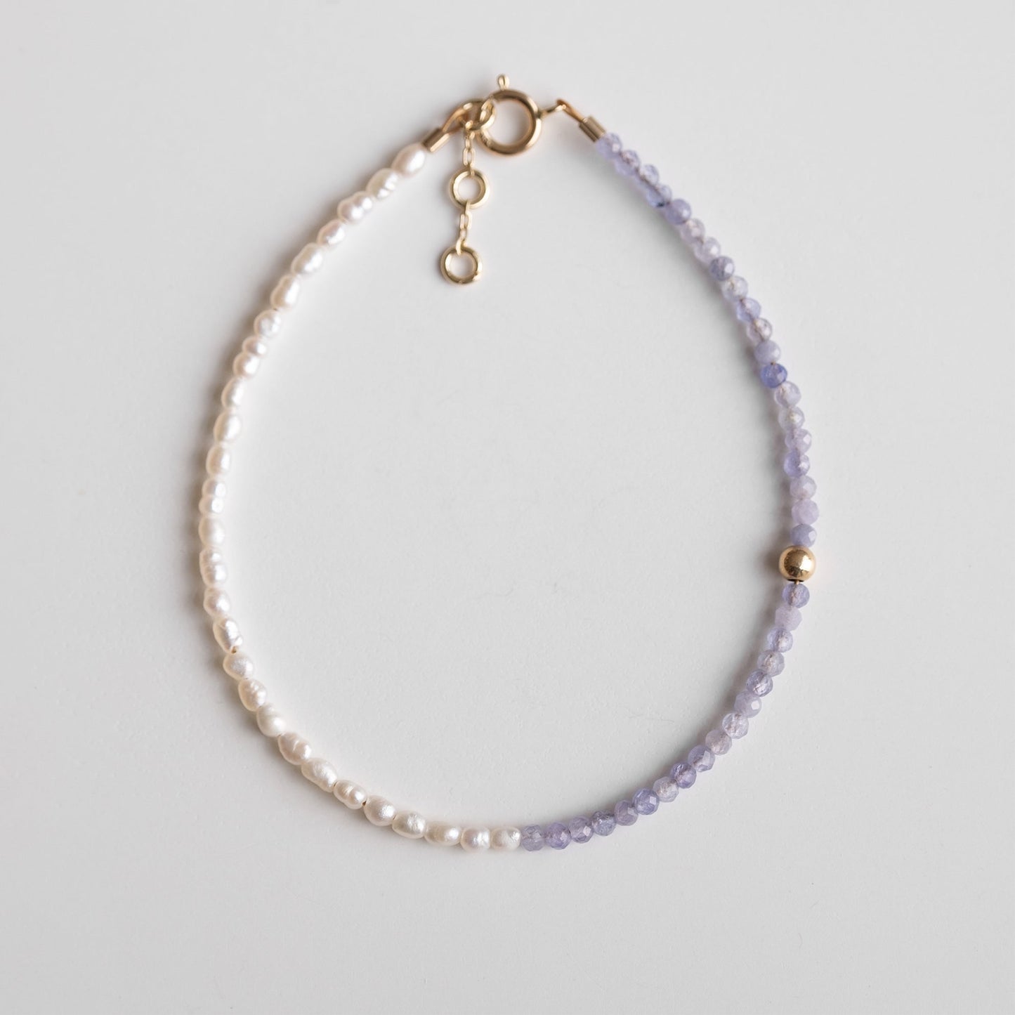 gold bracelet with pearls and purple stones 