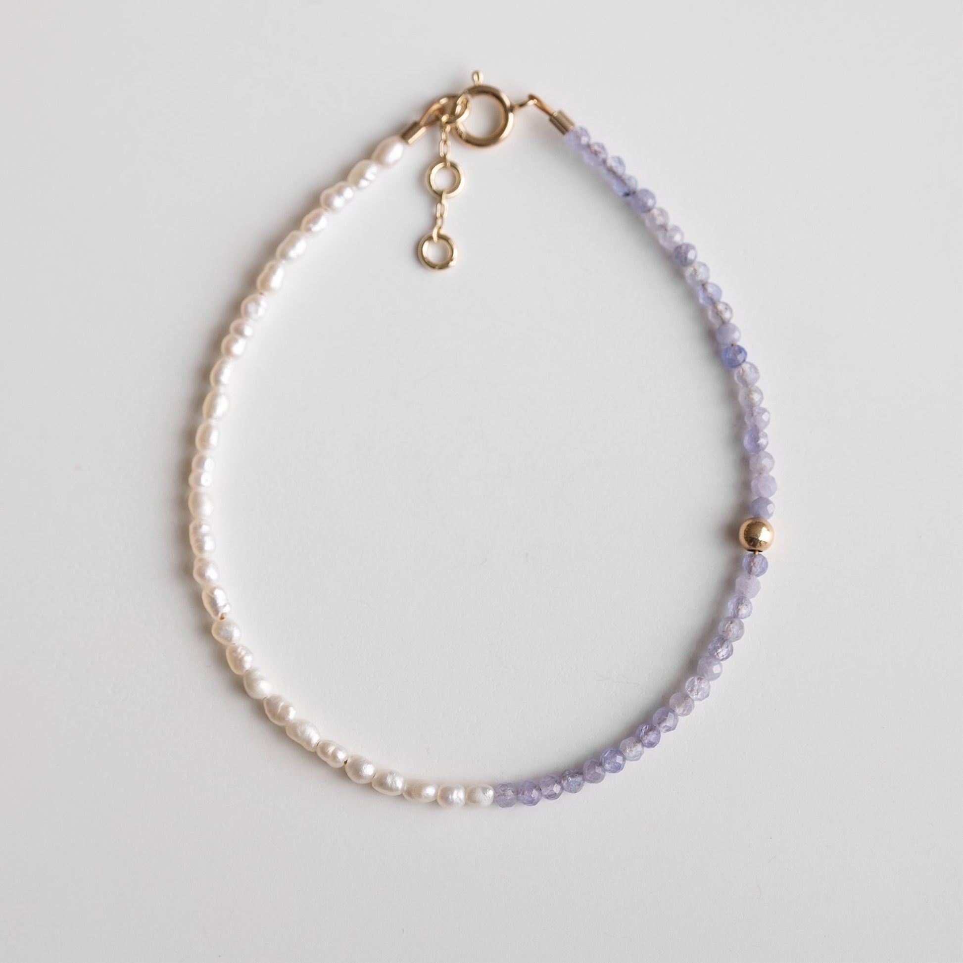 gold bracelet with pearls and purple stones 