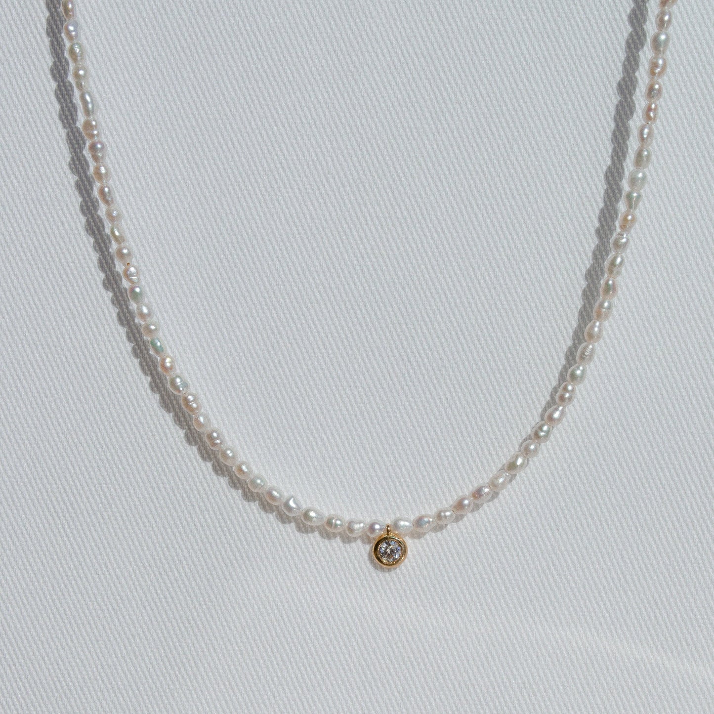 pearl beaded necklace with single large diamond 