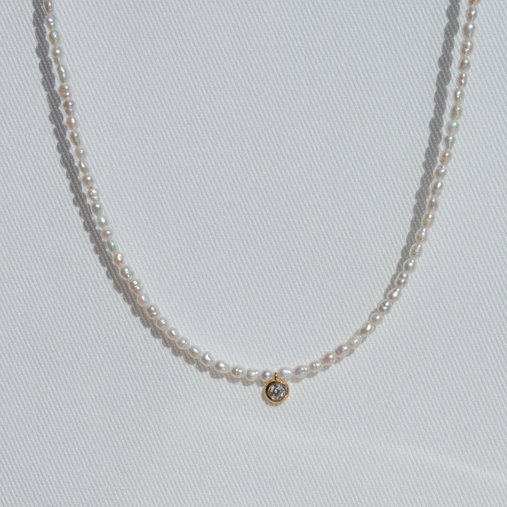 pearl beaded necklace with single large diamond 