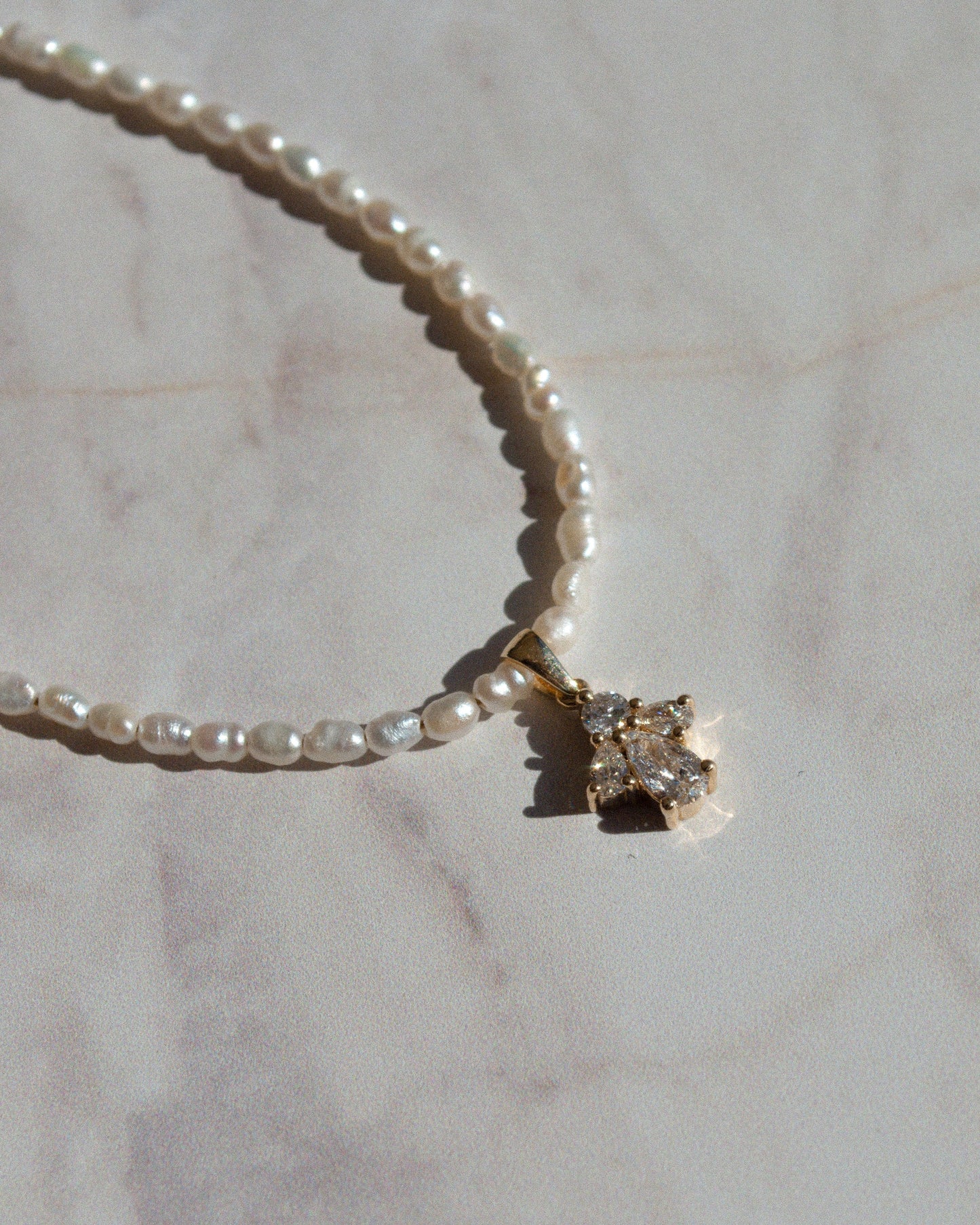 delicate beaded gold necklace with pearls and pear cut diamond pendant 