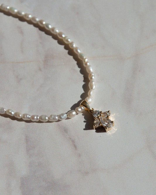 delicate beaded gold necklace with pearls and pear cut diamond pendant 