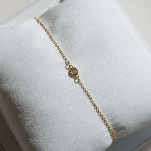 delicate gold chain bracelet with single diamond