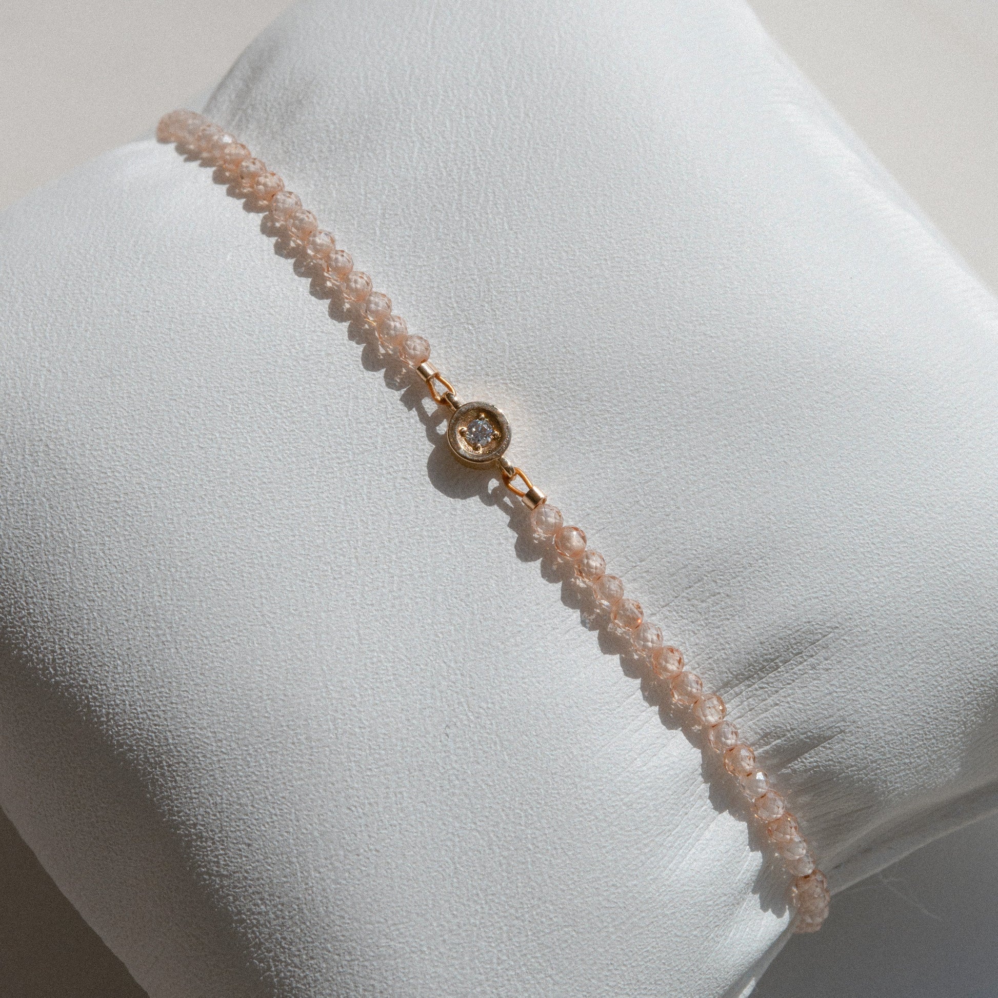 gold bracelet with beige beads and diamond 