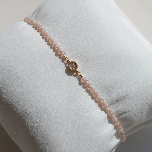 gold bracelet with beige beads and diamond 