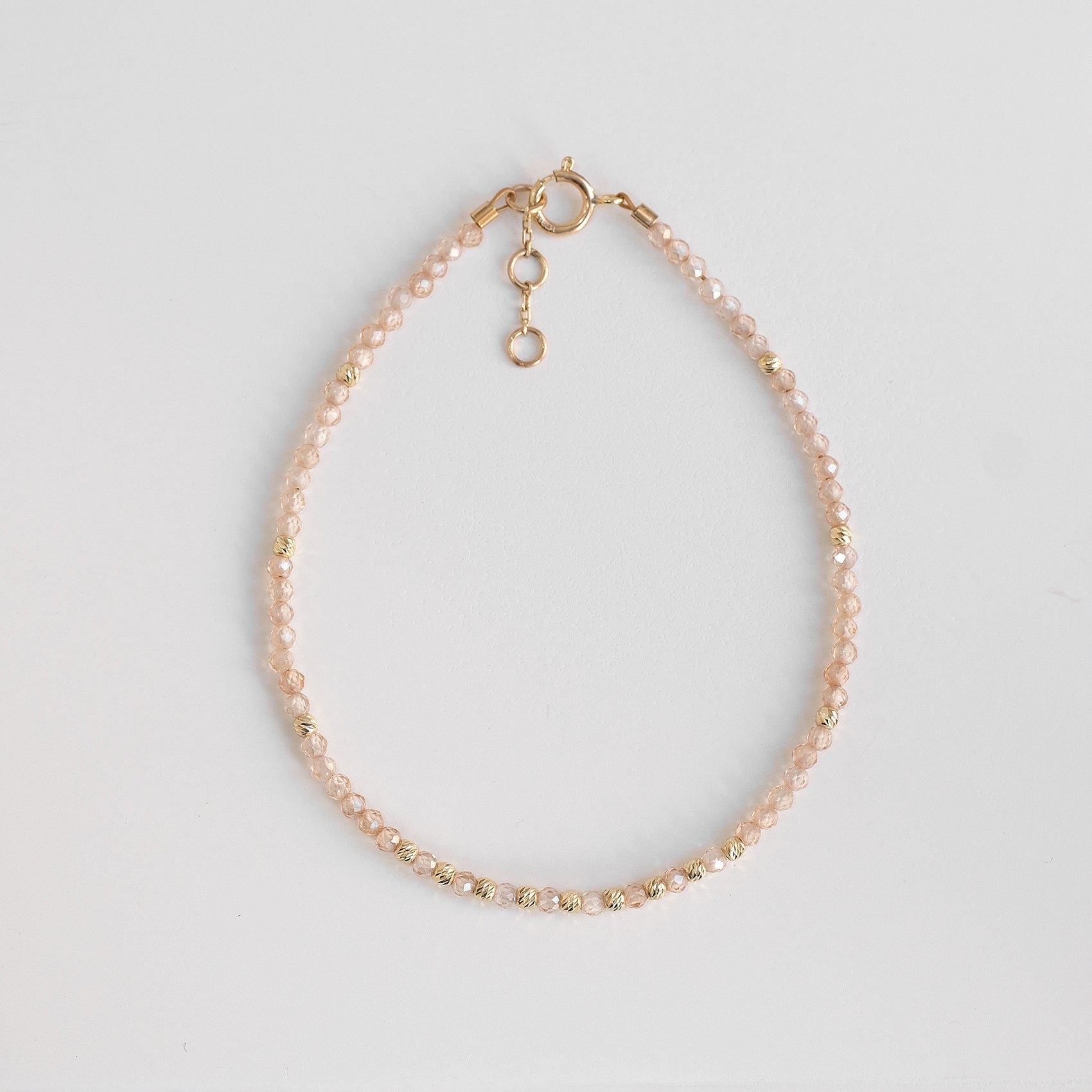 solid gold bracelet with delicate zirconia stones, beige beaded gold bracelet 